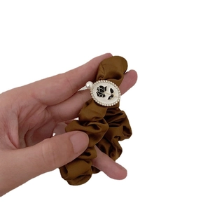 Elegant dark brown satin scrunchie with a black rose pendant and white pearl detail