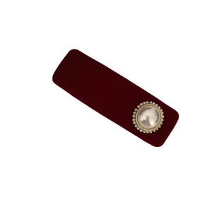 Elegant red velvet hair clip with a vintage pearl ornament on a white background