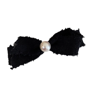 Elegant black tweed bow hair clip with a central white pearl for women's hair styling