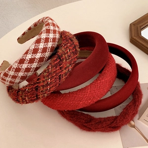 Detail of assorted vintage red headbands in velvet, tweed, and plaid textures