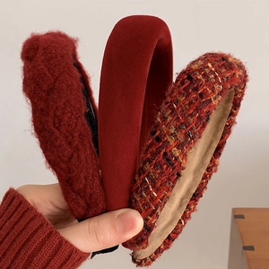 Detailed close-up of three red headbands in plush knit, velvet and tweed textures