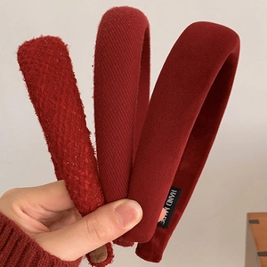 Three deep red padded headbands in tweed, knitted, and velvet textures for a retro style