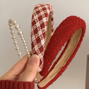 Detail view of pearl beads and red tweed hairbands with retro autumn winter texture