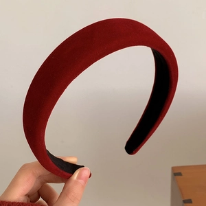 Detailed view of the thick red velvet headband showing soft texture and sponge padding