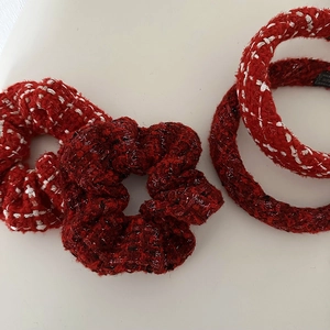 Close-up of red tweed scrunchie and headband set with metallic silver thread textures