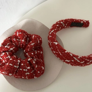 Elegant red and white tweed headband and scrunchie set on a stone tray for hair styling