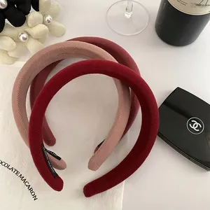Three textured knit sponge headbands in burgundy and rose pink with a handmade label