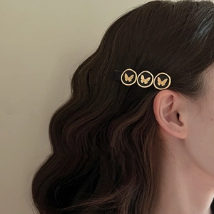 Retro vintage metal butterfly hair clip with gold relief details for women's hairstyle