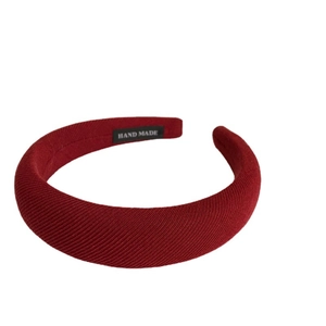 Chic burgundy sponge headband with ribbed knit texture and handmade interior label