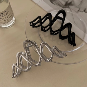 Minimalistische gewellte Haarklammern aus Metall in Mattschwarz und Silber für moderne Frisuren