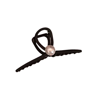 Matte black oversized hair claw clip featuring a large central pearl ornament