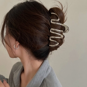 Large silver metal hair claw with elegant wavy lines for thick hair updo styles