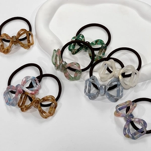 Close-up of hollow marble pattern resin bow hair ties in various gradient colors