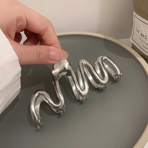 Polished silver metal hair claw clip with large wave design for thick hair styling