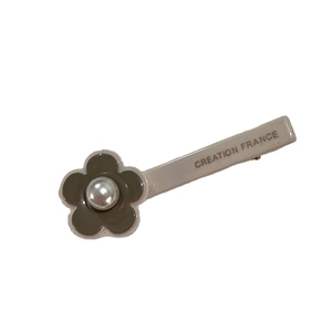 Elegant grey flower hair clip with pearl center and Creation France gold lettering