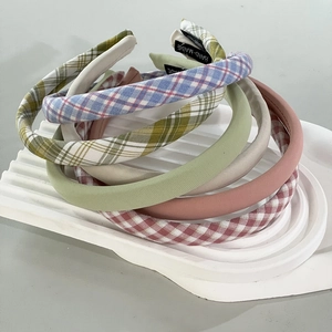 Close-up of handmade thick sponge headbands with gingham patterns and solid pastel colors