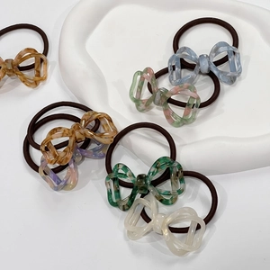 Collection of hollow marble pattern bow hair ties in various elegant gradient colors