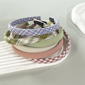 Five-piece handmade plaid and solid color fabric headband set for women on a display board