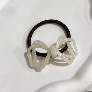 Elegant Korean style hollow bow hair tie with pearl finish and brown elastic band