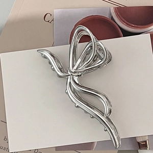 Silver metallic butterfly hair claw clip with a glossy minimalist ribbon design