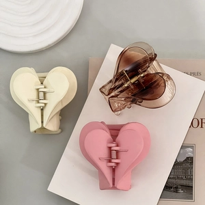 French heart-shaped acrylic hair claws in matte pink, cream white, and amber set