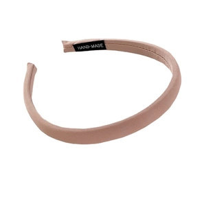 Classic pink fabric headband for women with a handmade label on a clean white background