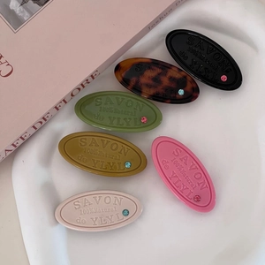 Oval resin hair clips with crystal inlay and SAVON engraving in six assorted colors