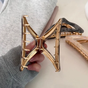 Elegant large triangle acetate hair claw clip for thick hair in luxury gold and smoky grey