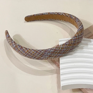 Close-up of the woven tweed pattern and soft suede inner lining of this vintage headband