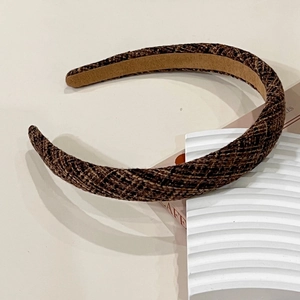 Detailed view of the dark brown tweed texture and non-slip suede lining of this vintage headband
