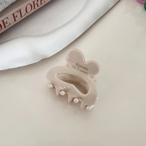 Detail showing the inner engraved lettering Barrette la France on a cream hair clip