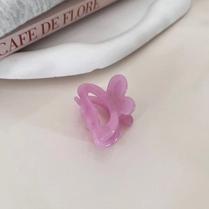 Close-up of translucent purple butterfly hair clip for elegant hairstyle accent