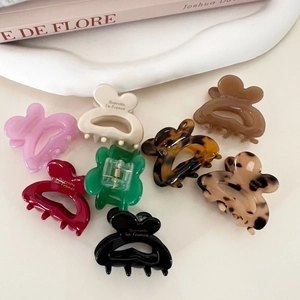 French style bow hair clips in assorted colors on a minimalist white background