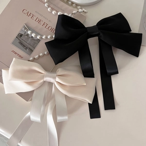 Elegant large satin bow hair clips in black and cream white with long ribbons