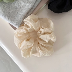 Detailed view of cream ruffled mesh hair tie with lightweight organza silk texture