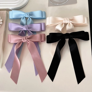 Solid color satin bow hair clips set in light blue, purple, and pink for women