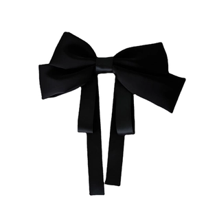 Elegant large black satin ribbon bow hair clip with long streamers for women on white background