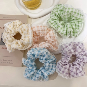 Set of five pastel plaid scrunchies with white lace edges in yellow, pink, and blue
