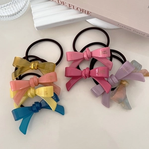 Colorful acetate bow hair ties in vibrant yellow, pink and blue for women's hairstyles