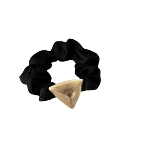 Black satin scrunchie featuring a brushed gold geometric triangle charm accessory