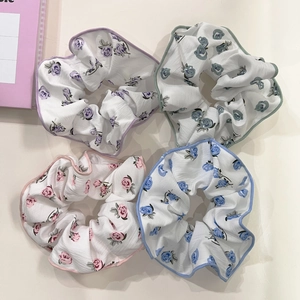 Set of four floral fabric scrunchies in pastel colors for high ponytail styling