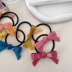 Colorful acetate bow hair tie set featuring elegant French lettering on white tray