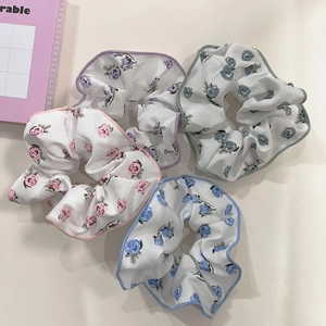 Set of four floral print scrunchies in pink, blue, green and purple colors