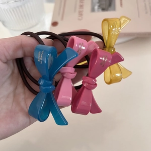 Set of four colorful acetic acid bow hair ties with gold lettering for elegant styling
