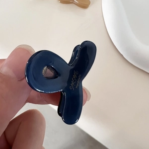 Mini navy blue acetate hair claw clip with golden logo for women's side hair styling