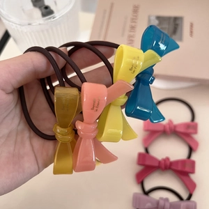 Close-up of colorful acrylic bow hair ties with elastic bands in vibrant macaron tones