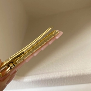 Pink resin geometric alligator hair clip with gold metal base and wave texture