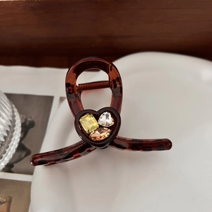 Elegant tortoiseshell hair claw clip with colorful heart-shaped rhinestones for women