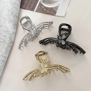 Three metal butterfly hair claws with opal stone centers in gold, silver and gun black
