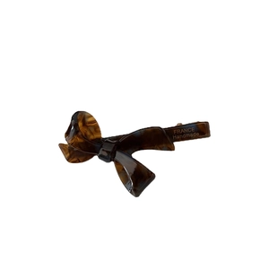 Tortoiseshell acetate bow hair clip with France Handmade gold lettering on white background